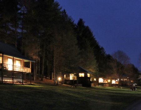 Log Cabins, December Night 01s Log Cabins (4) and Cedar Center conference room (center)